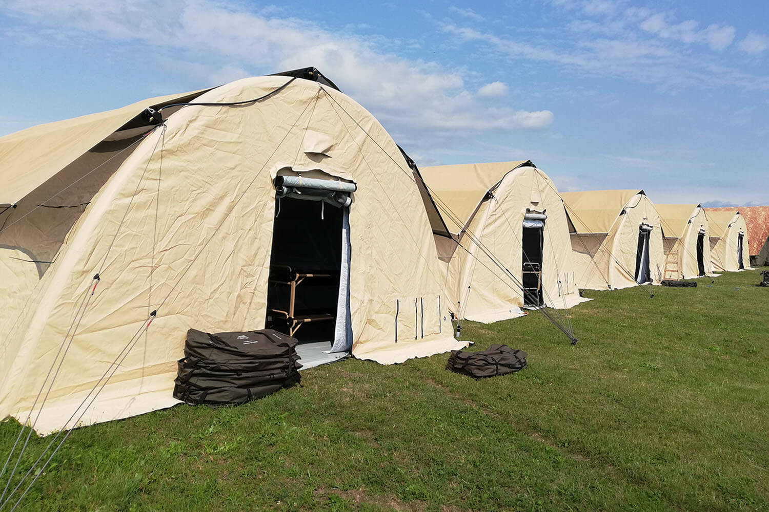 Multiple rapid deploy Nixus PRO inflatable military tents in a row